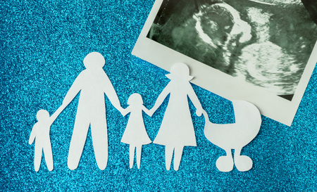 91860679 - paper image of happy families who are expecting another child.